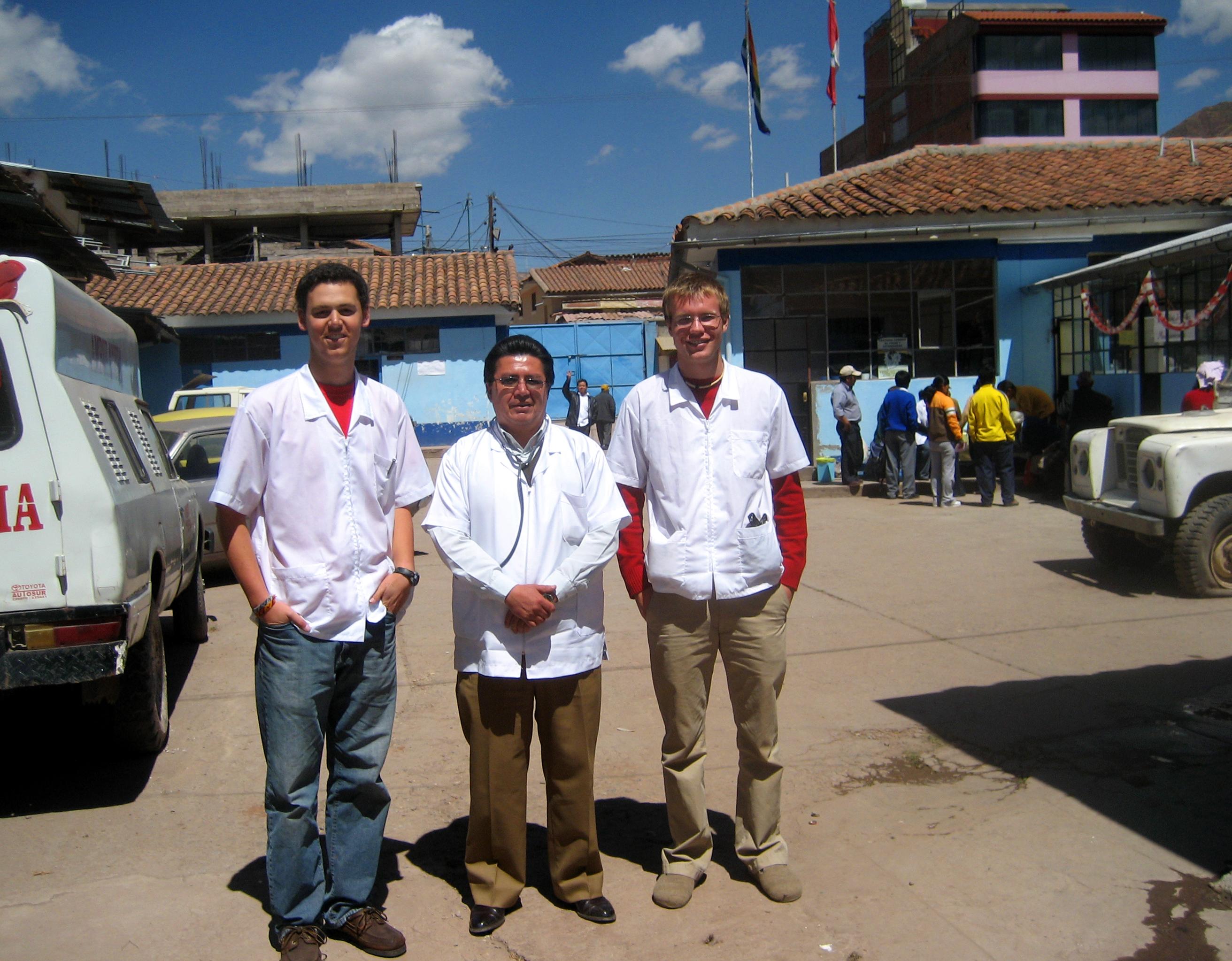Two interns from Projects Abroad take a photo with a local doctor outside the hospital whilst on their nursing internship in Peru. Two male interns with Projects Abroad take a picture with a local doctor outside the hospital during their nursing internship in Peru.